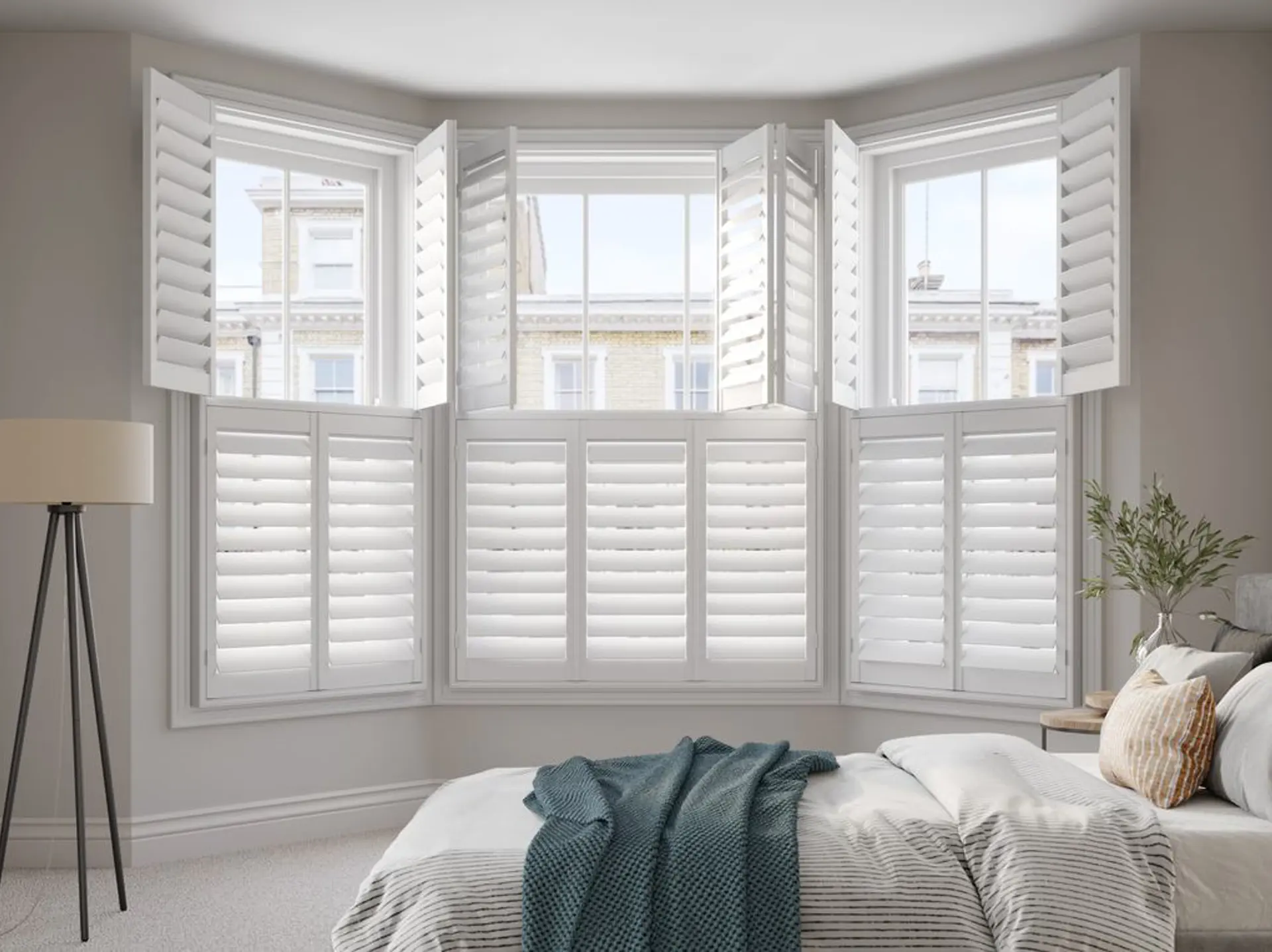 Vivid White tier on tier bay window wooden shutters in bedroom