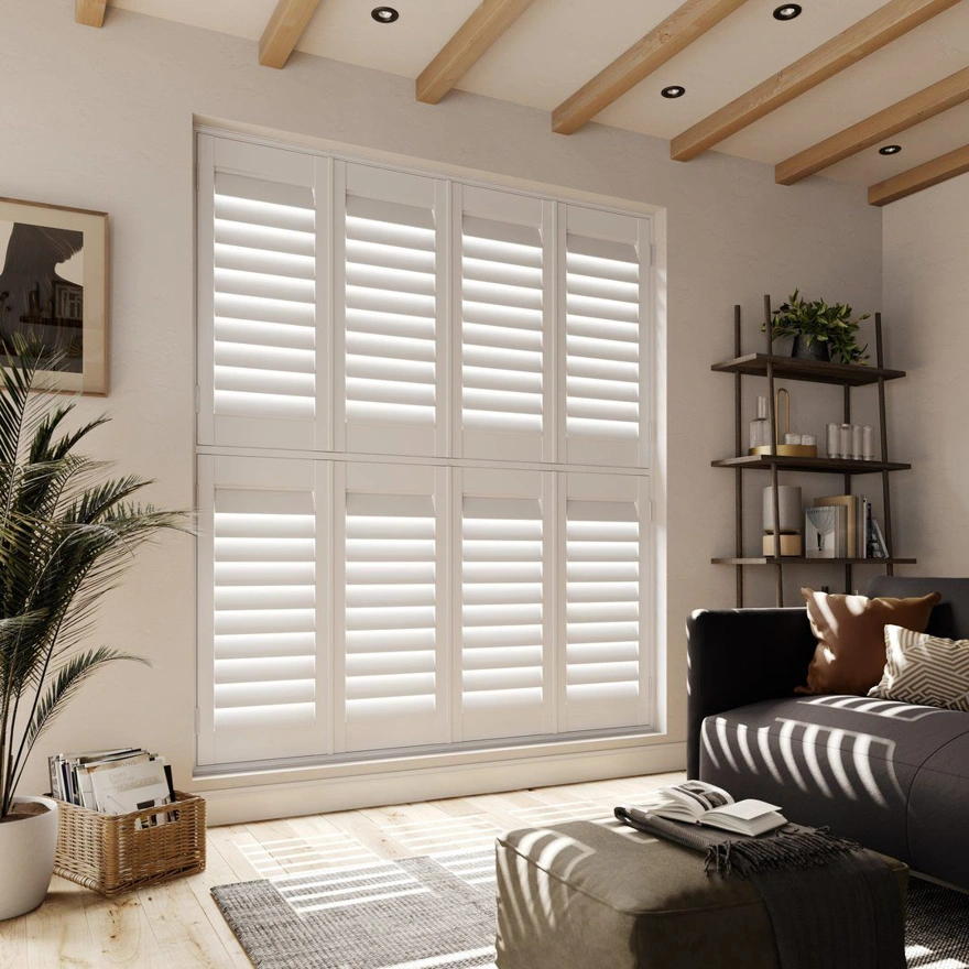 A neutral living room with Silk White tier on tier faux wood shutters 