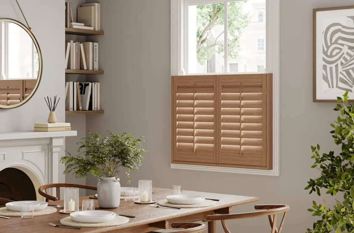 Honey stained wooden cafe style shutters in neutral dining room