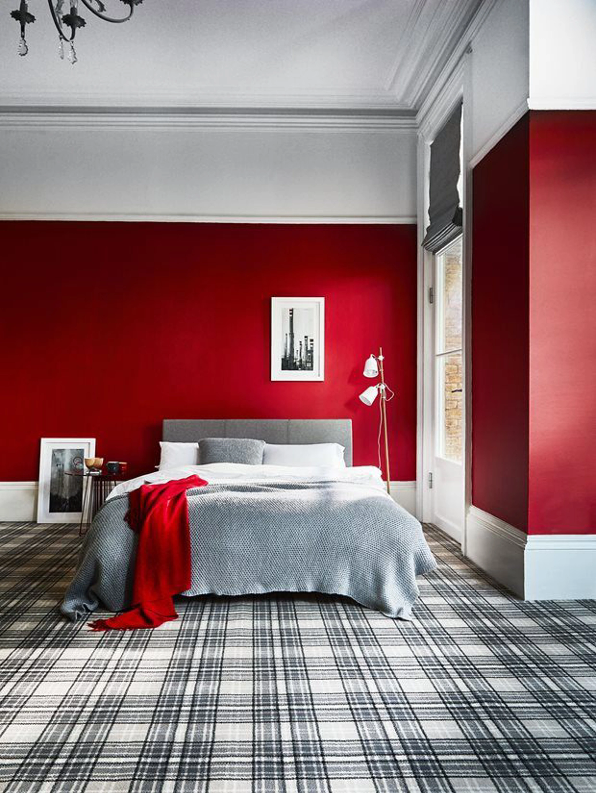 Bedroom with red walls and chequered carpet