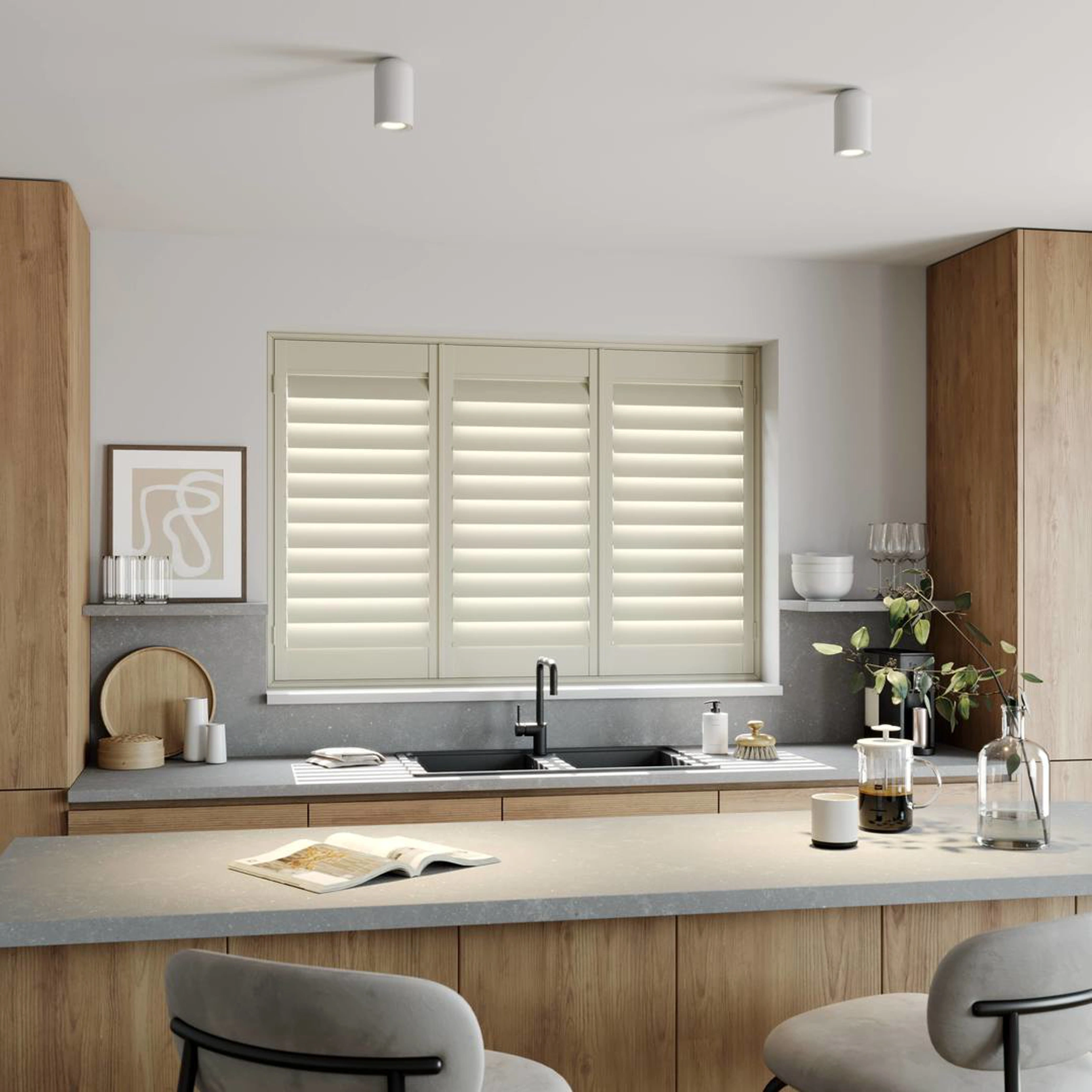 A modern kitchen with Cream full height wooden shutters 