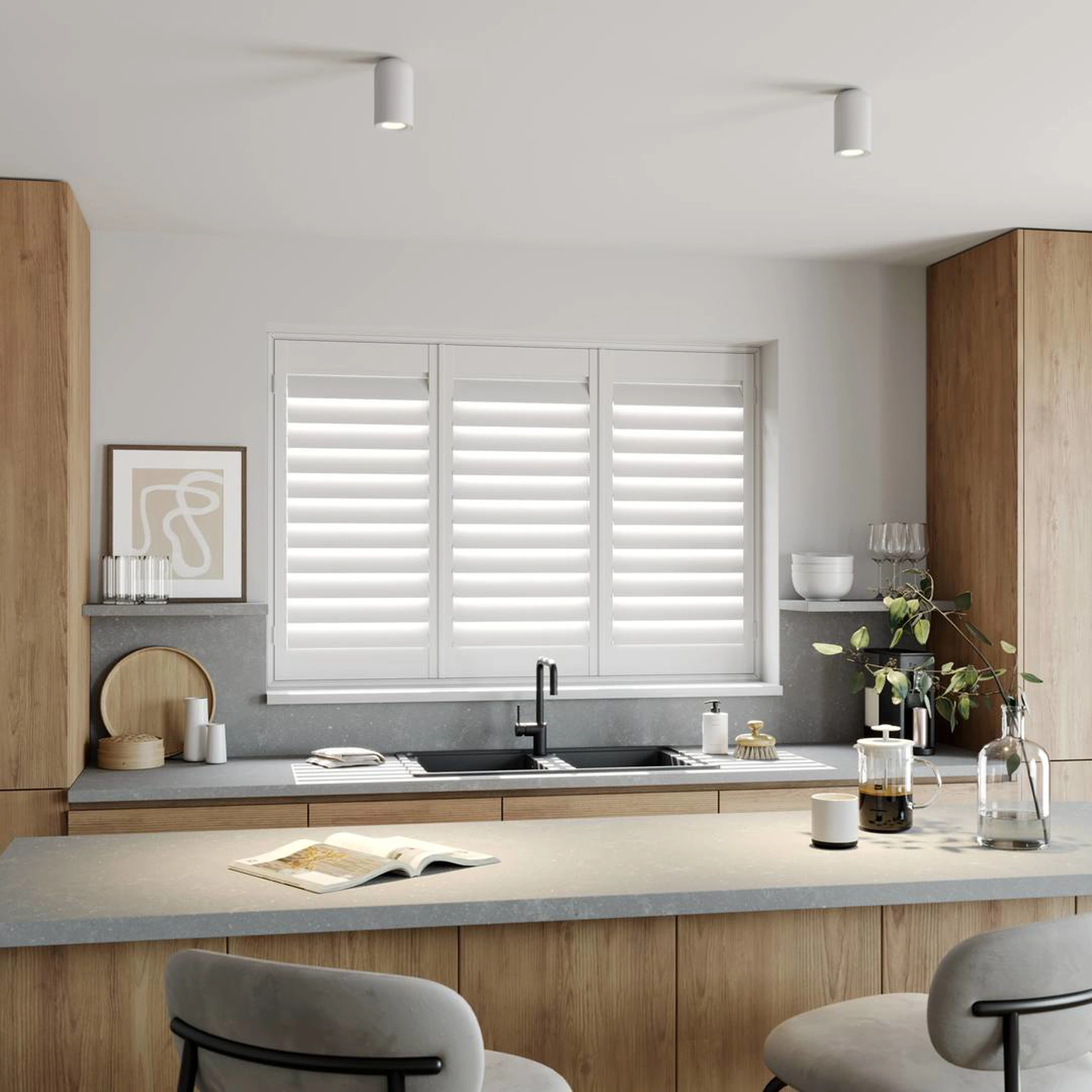 A modern kitchen with Traffic White full height wooden shutters 