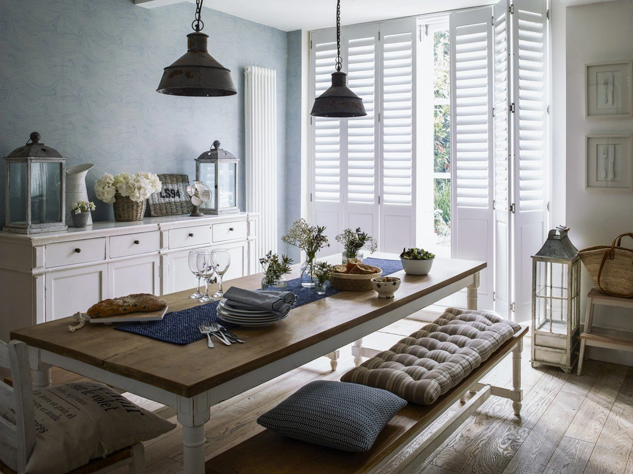Vivid White combination wooden shutters in traditional kitchen with large wooden bench table