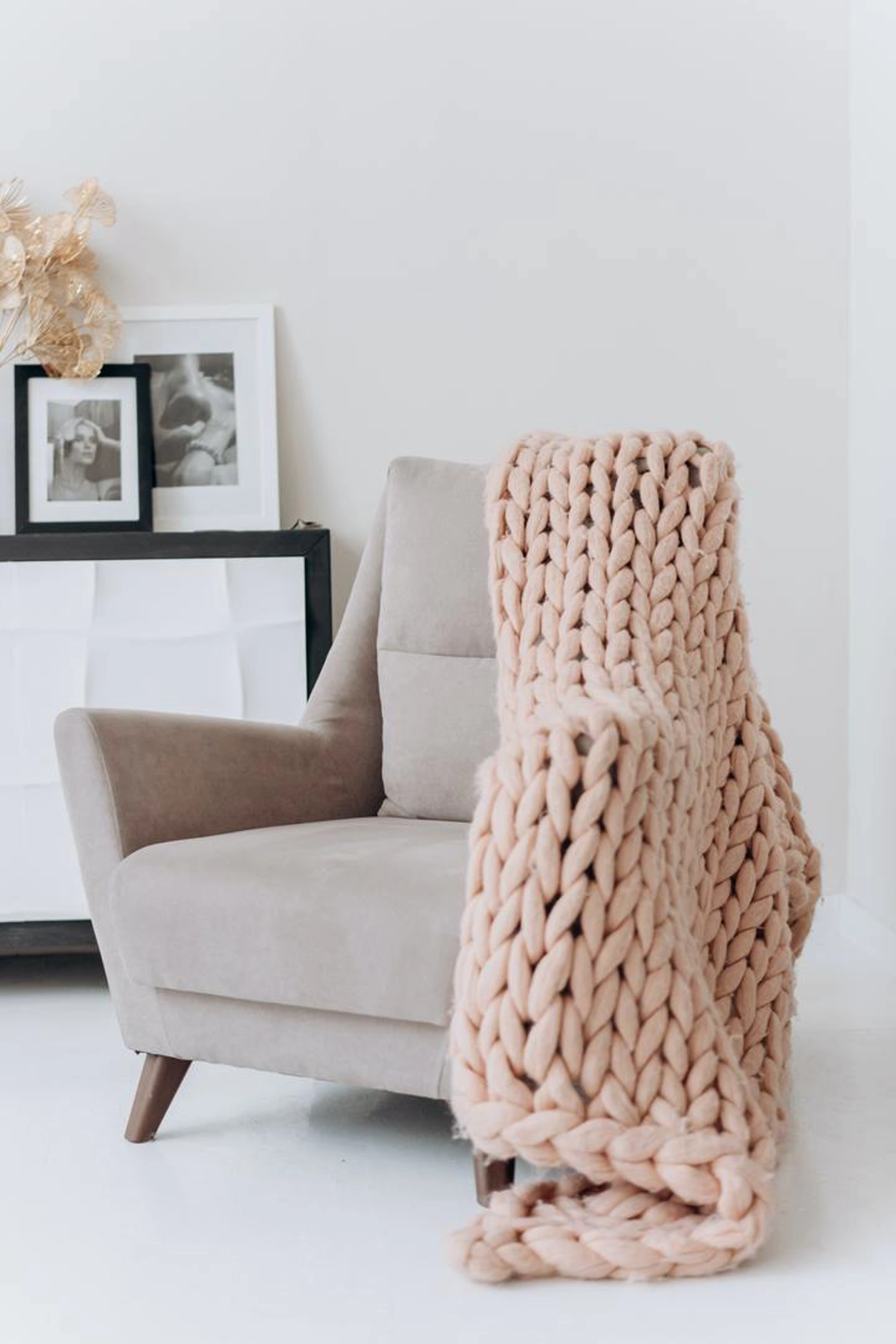 Grey armchair with pink large knit throw