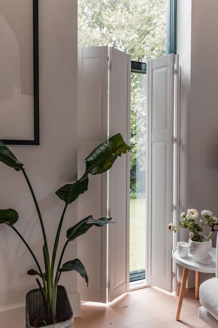 Cafe style solid raised Vivid White wooden shutters