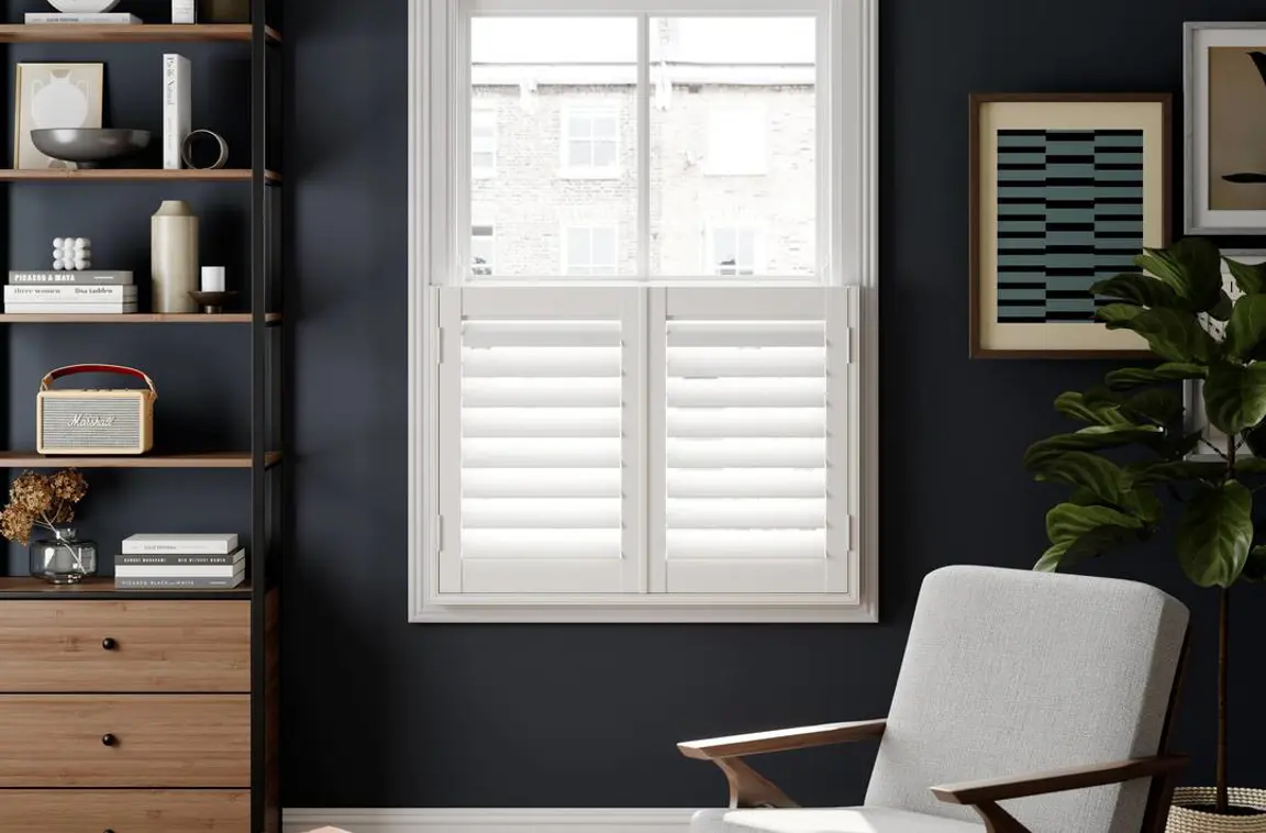 A navy living room with Silk White cafe style faux wood shutters 