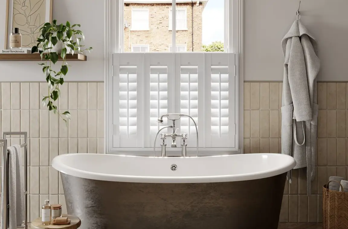 Vivid White cafe style faux wood shutters in traditional bathroom