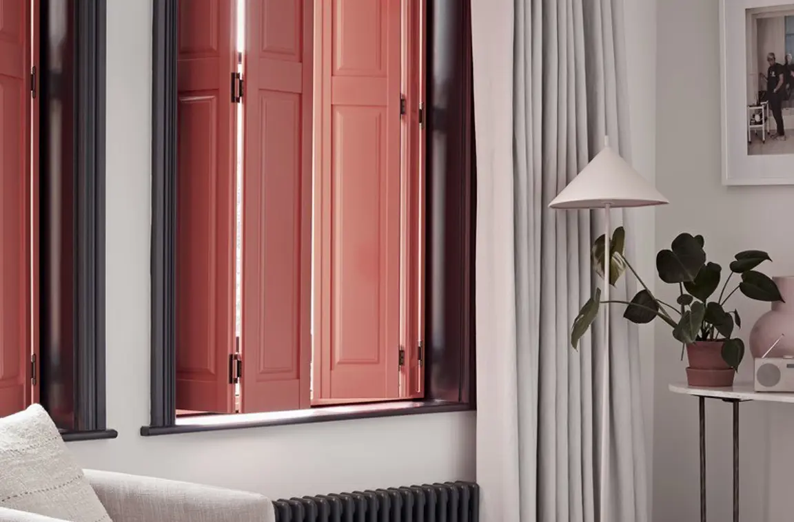 Peach solid raised wooden shutters in living room