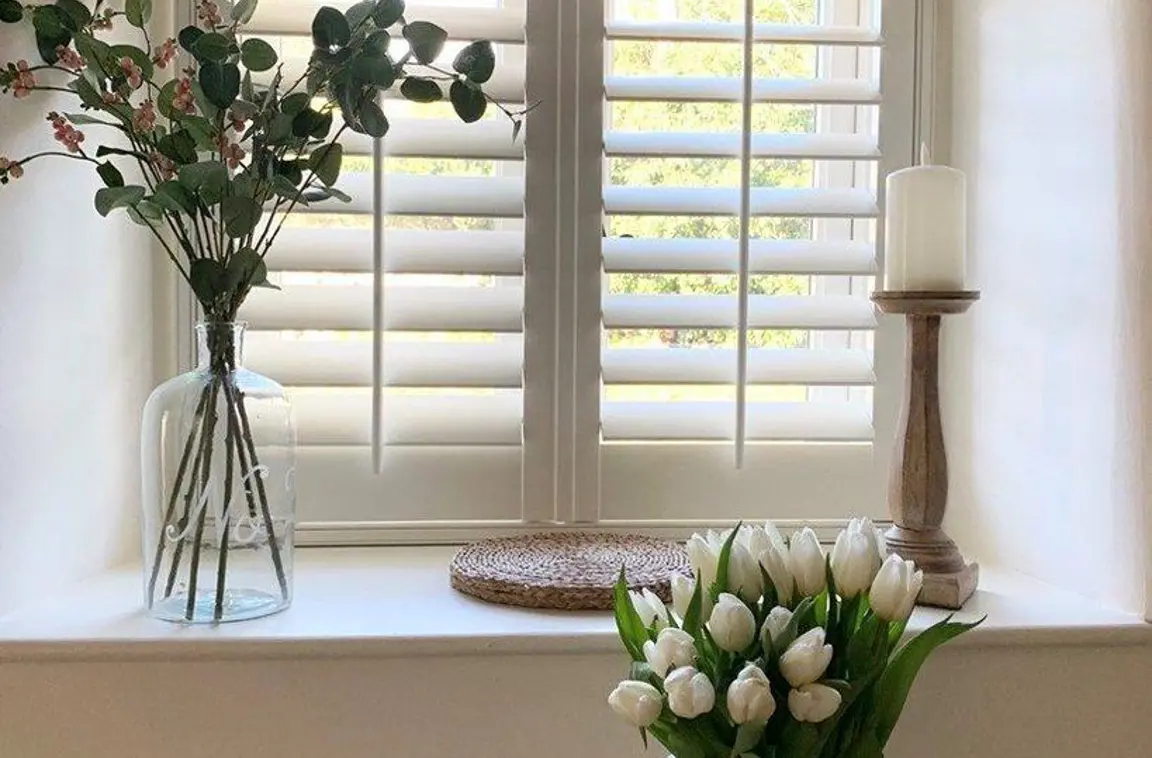 Traffic white wooden shutters in vintage cottage