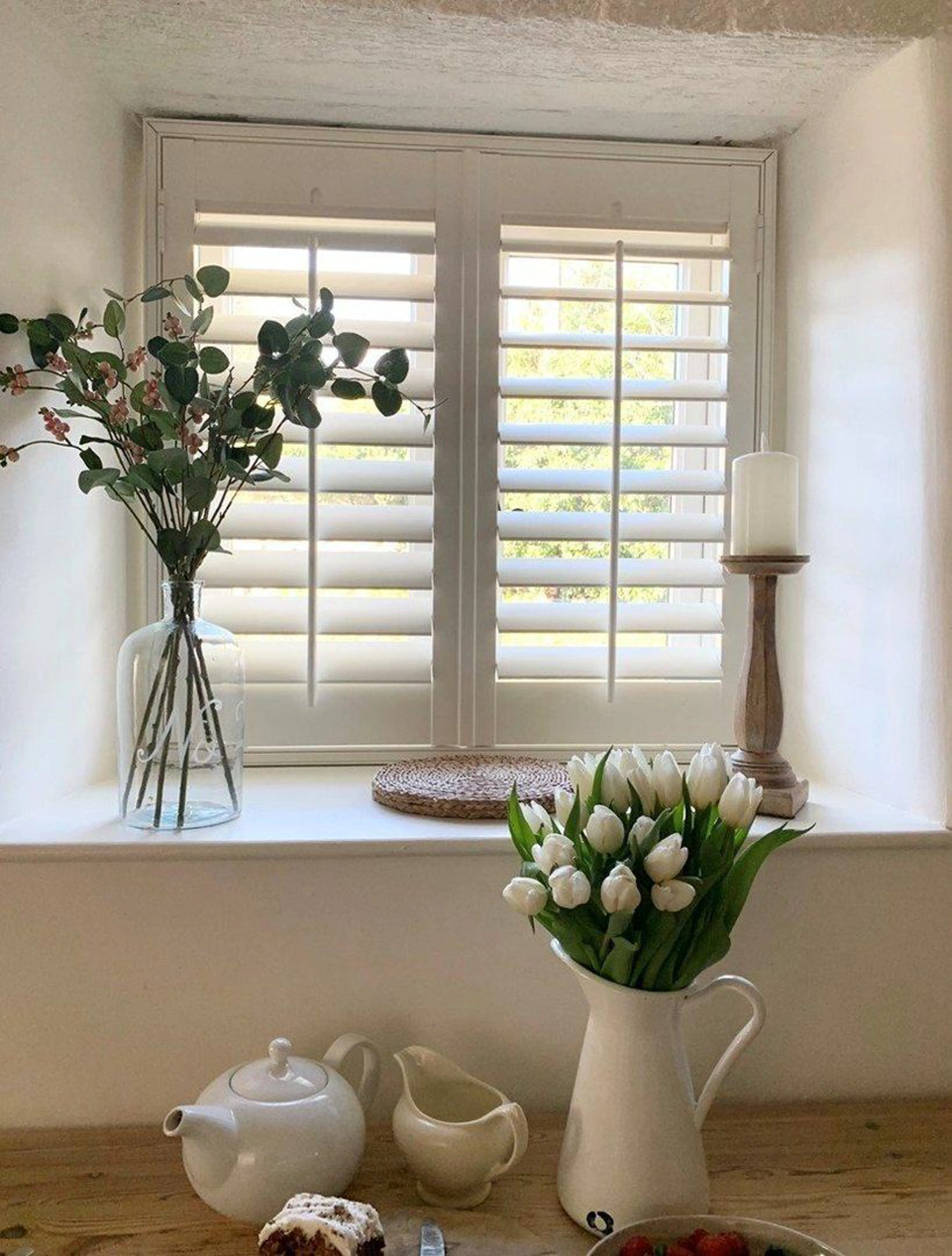 Traffic white wooden shutters in vintage cottage
