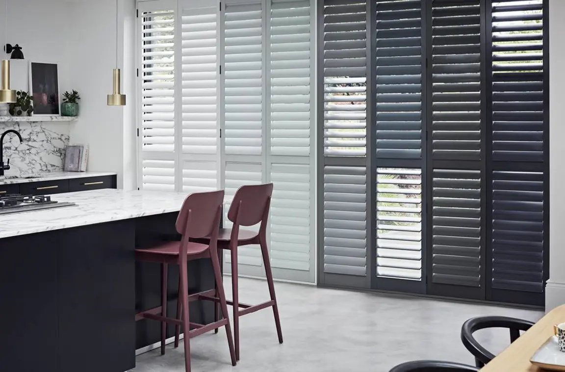 Grey and White tracked wooden shutter on patio doors in kitchen