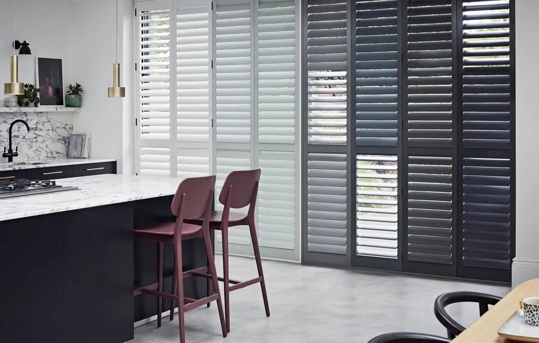 Grey and White tracked wooden shutter on patio doors in kitchen