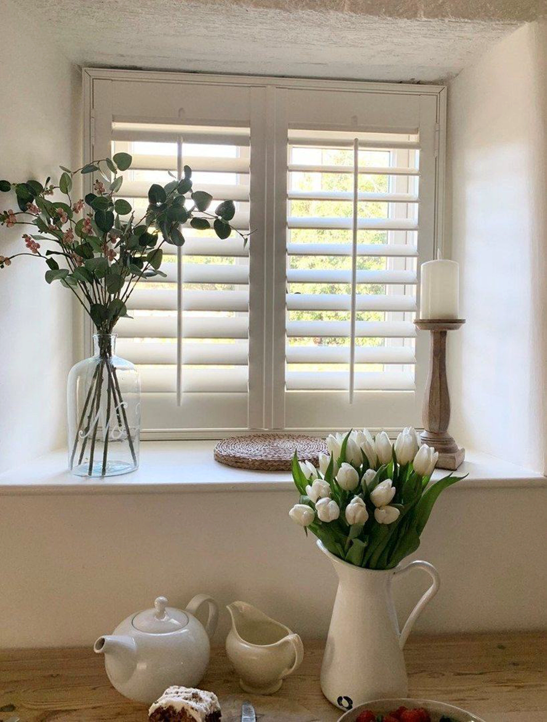 Traffic White full height wooden shutters in cottage window
