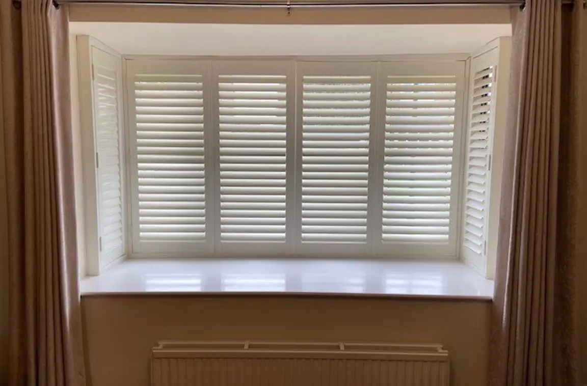 Box bay window with wooden shutters in Vivid White