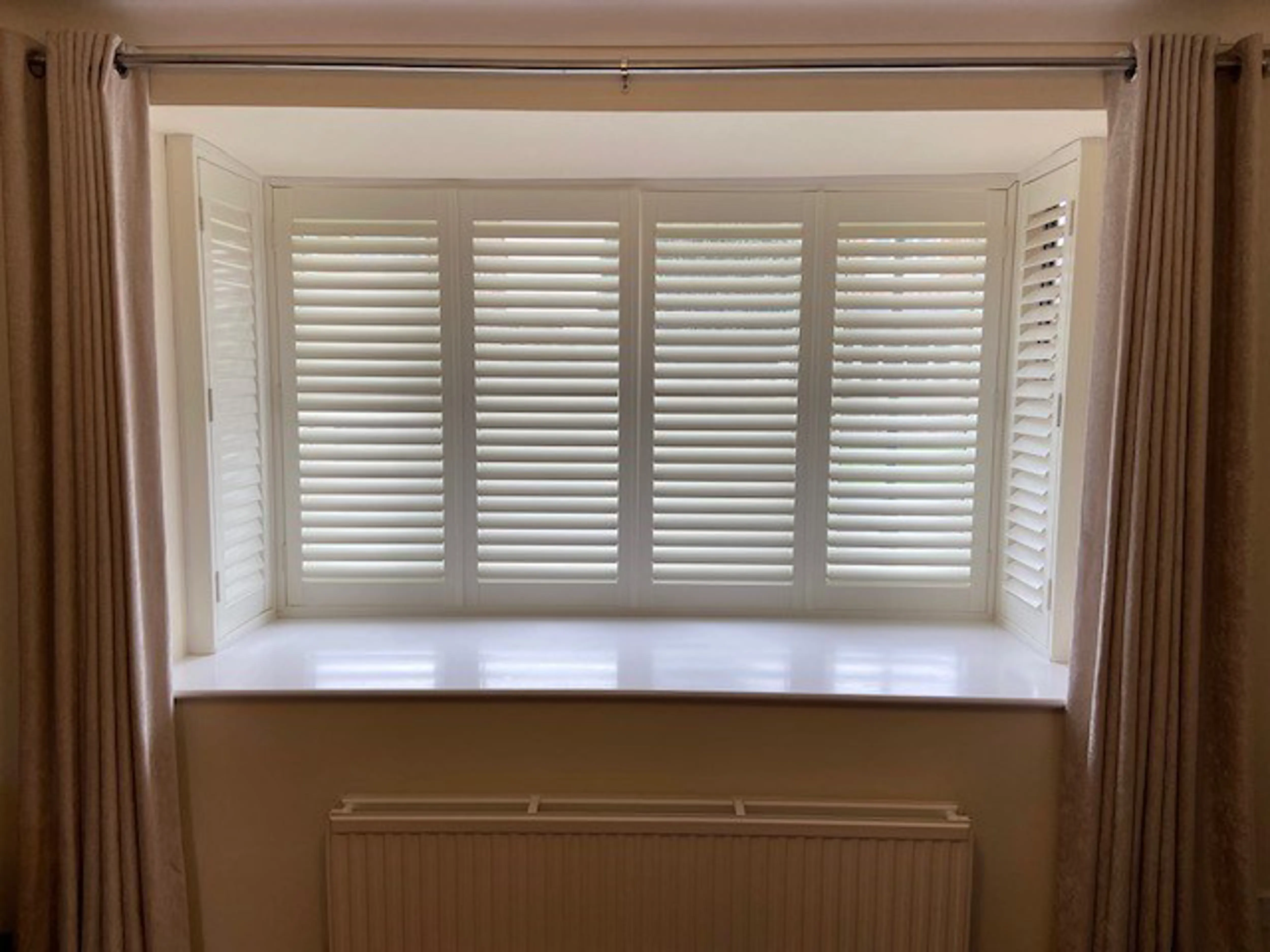 Box bay window with wooden shutters in Vivid White