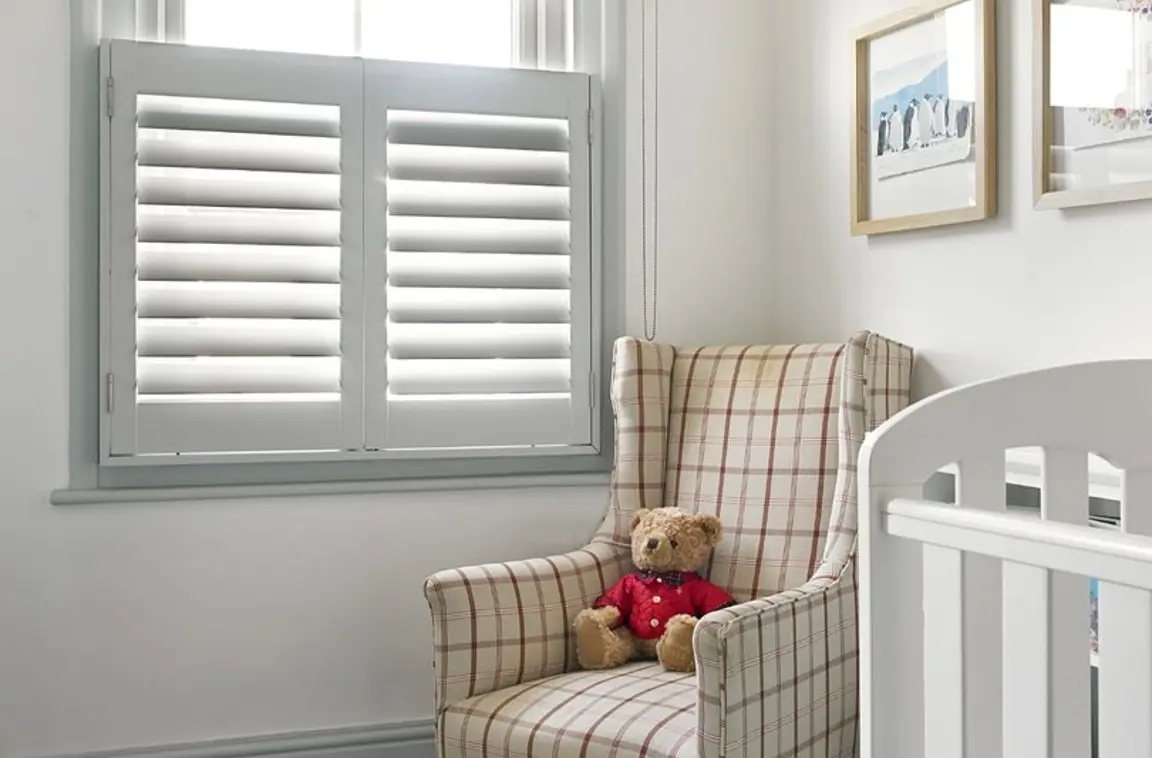 Signal grey wooden window shutters in traditional nursery