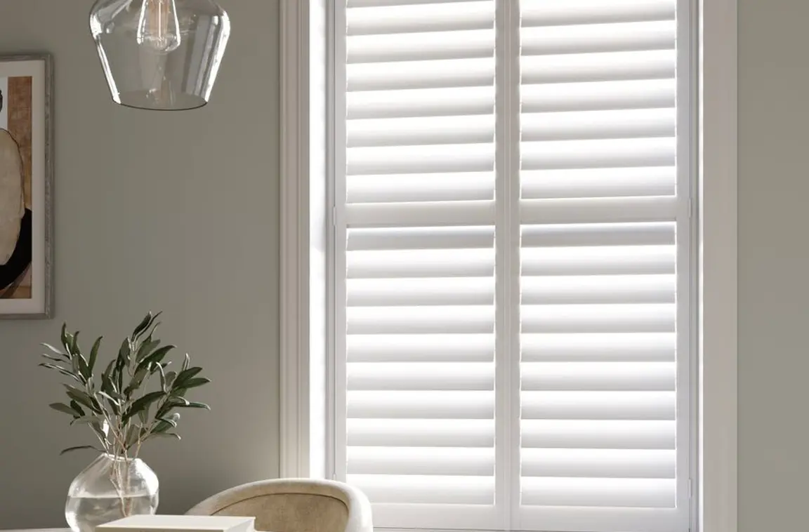 Vivid White full height wooden shutters in dining room