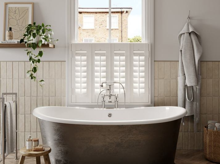 A traditional bathroom with Silk White cafe style faux wood shutters 