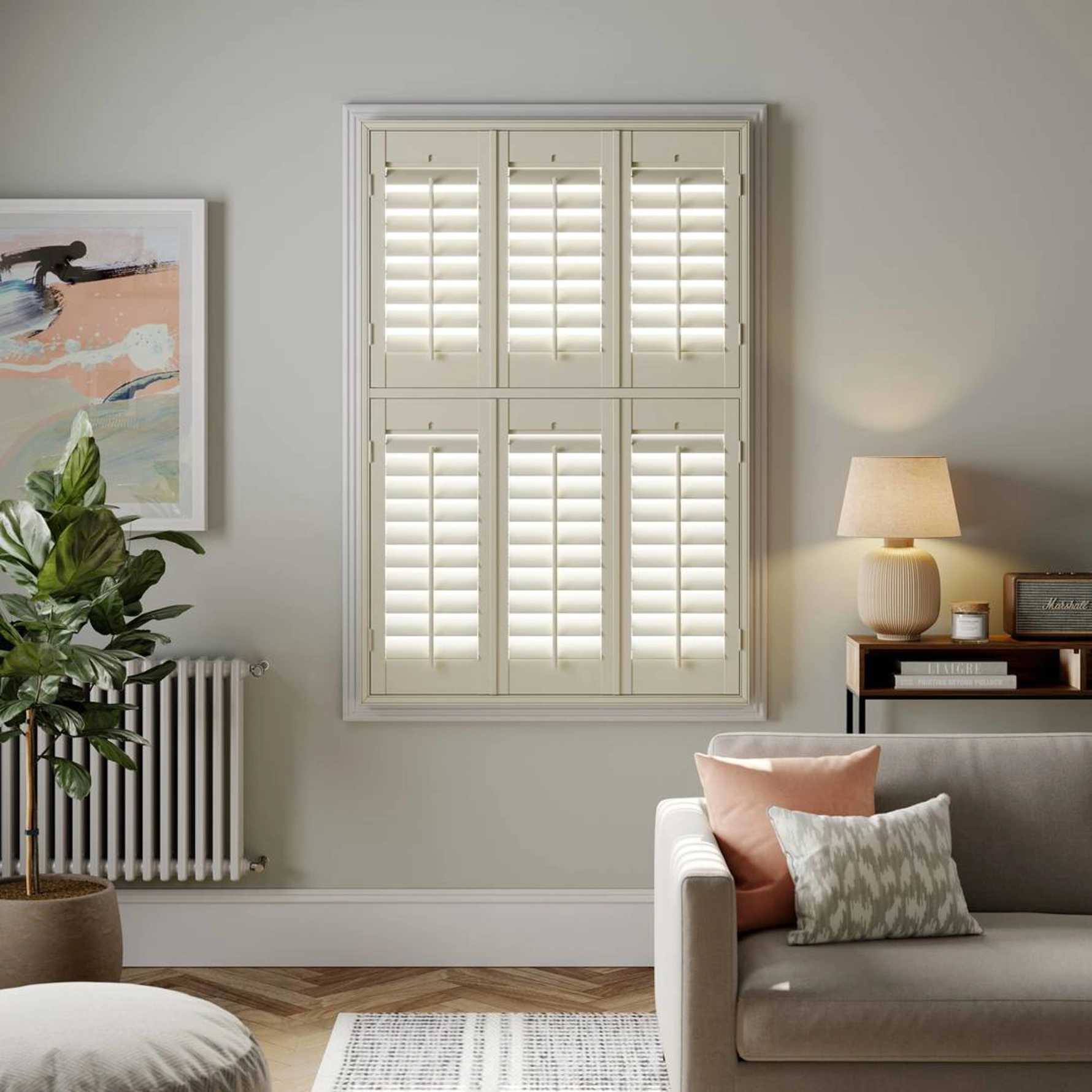 A modern living room with Cream tier on tier wooden shutters 