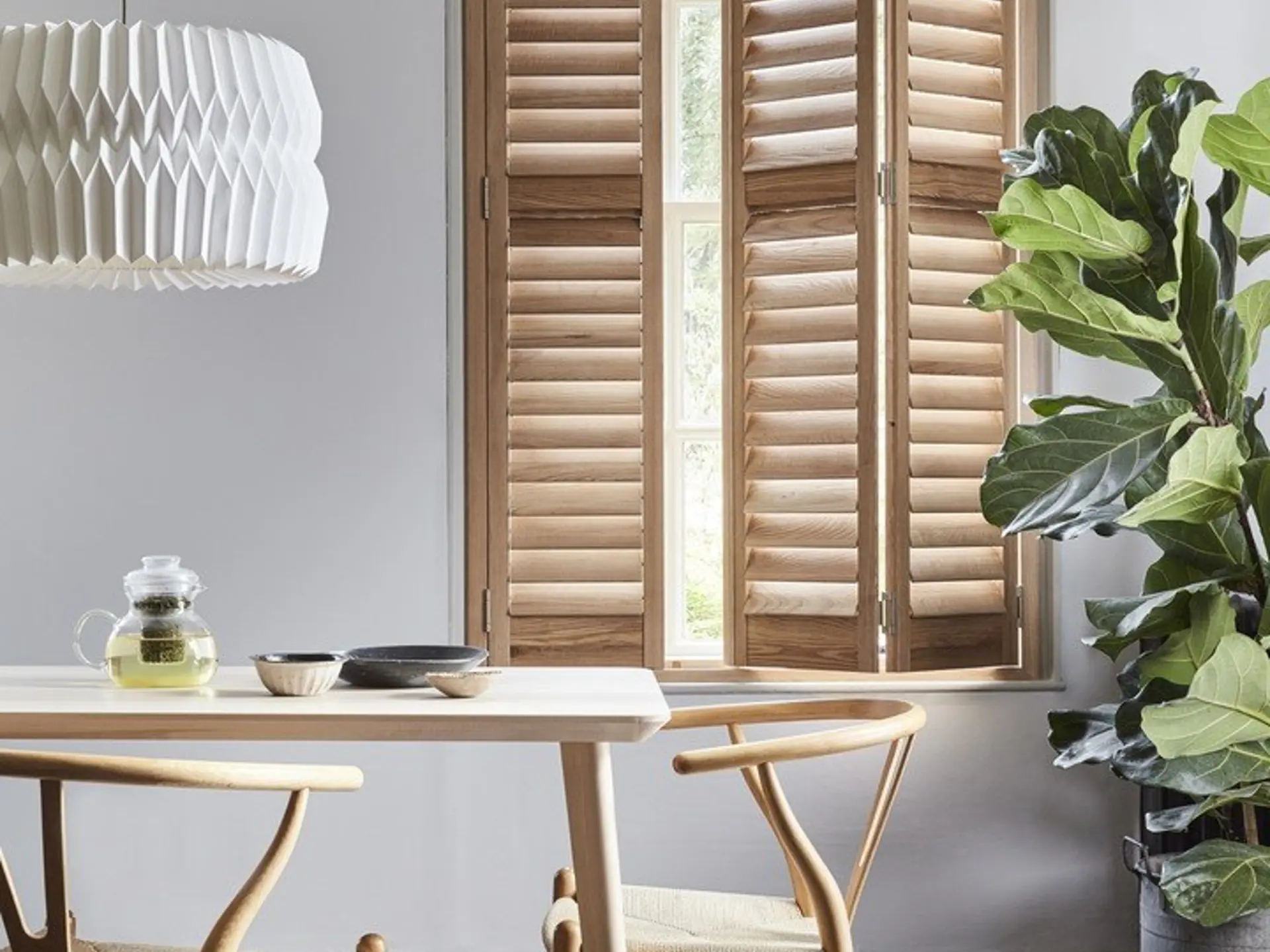 Honey Stained wooden full height shutters in dining room