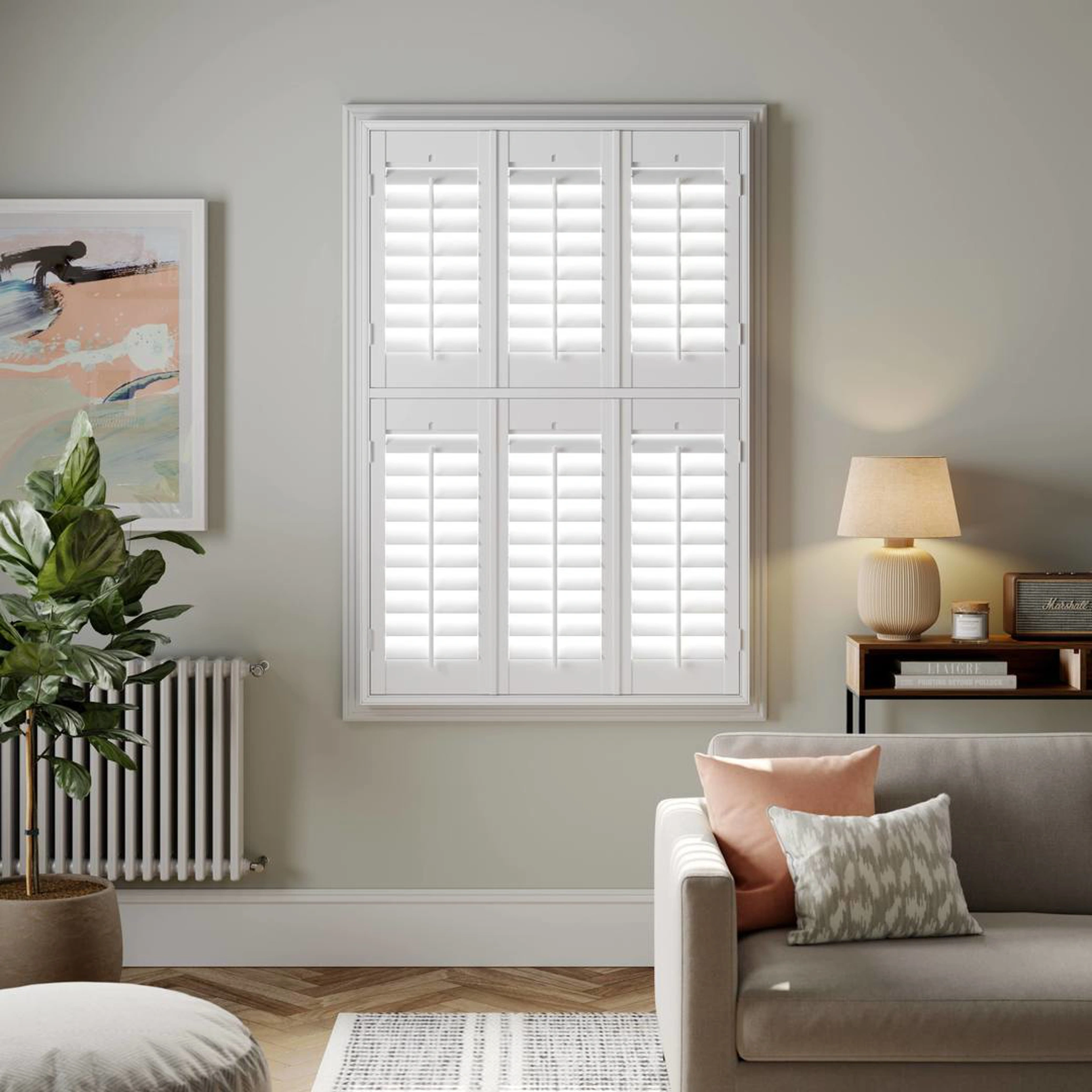 A modern living room with Vivid White tier on tier wooden shutters 