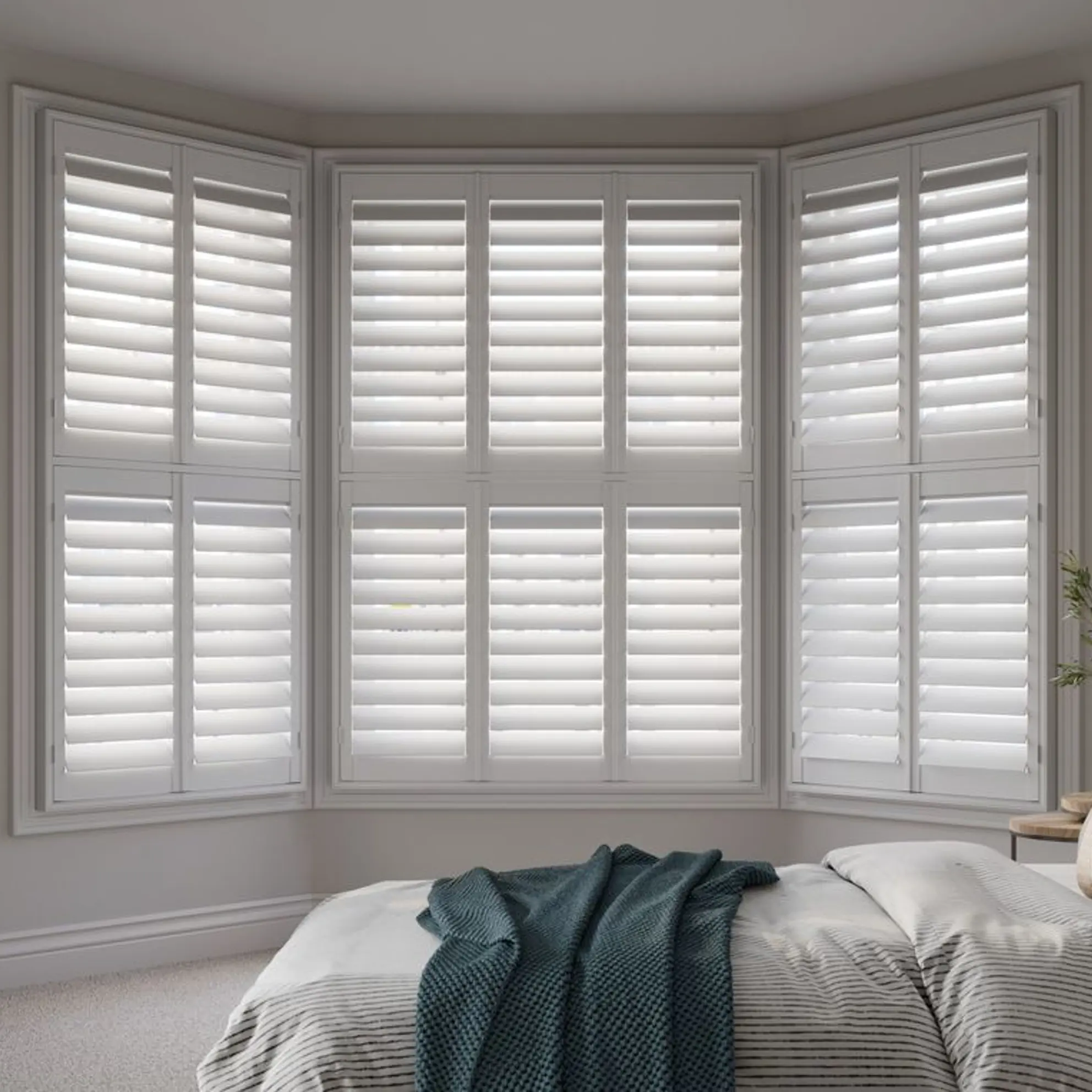 White bay wooden shutters in neutral bedroom