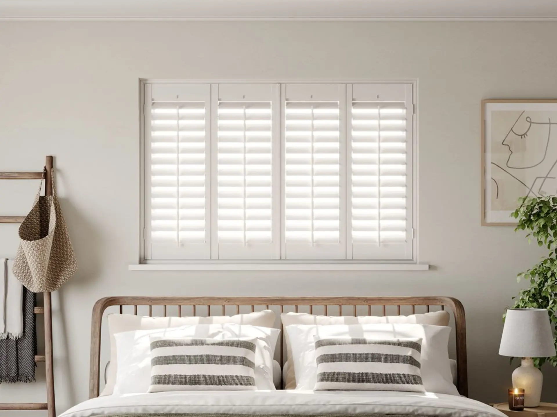 A modern neutral bedroom with Traffic White full height wooden shutters