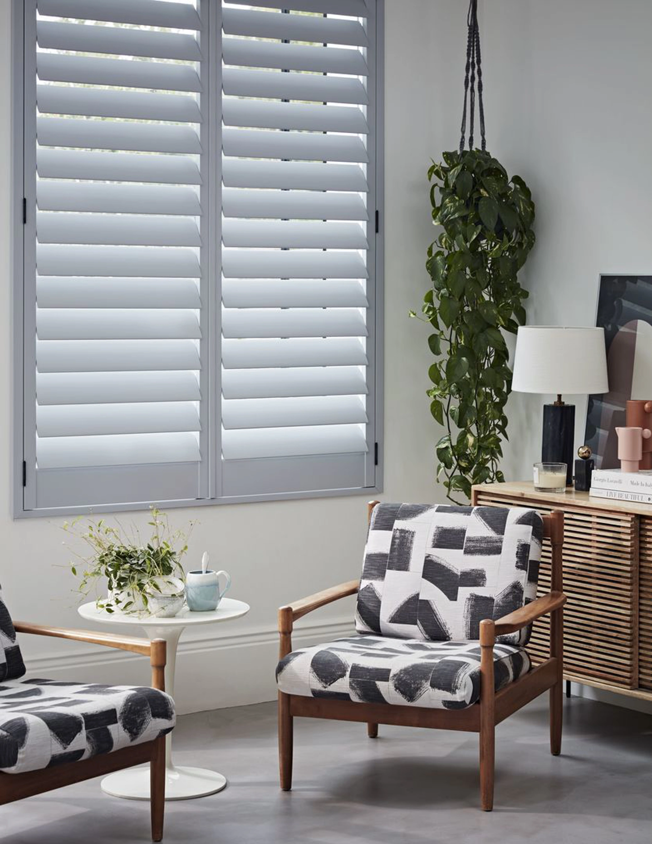 Signal Grey wooden shutters with black and white armchairs
