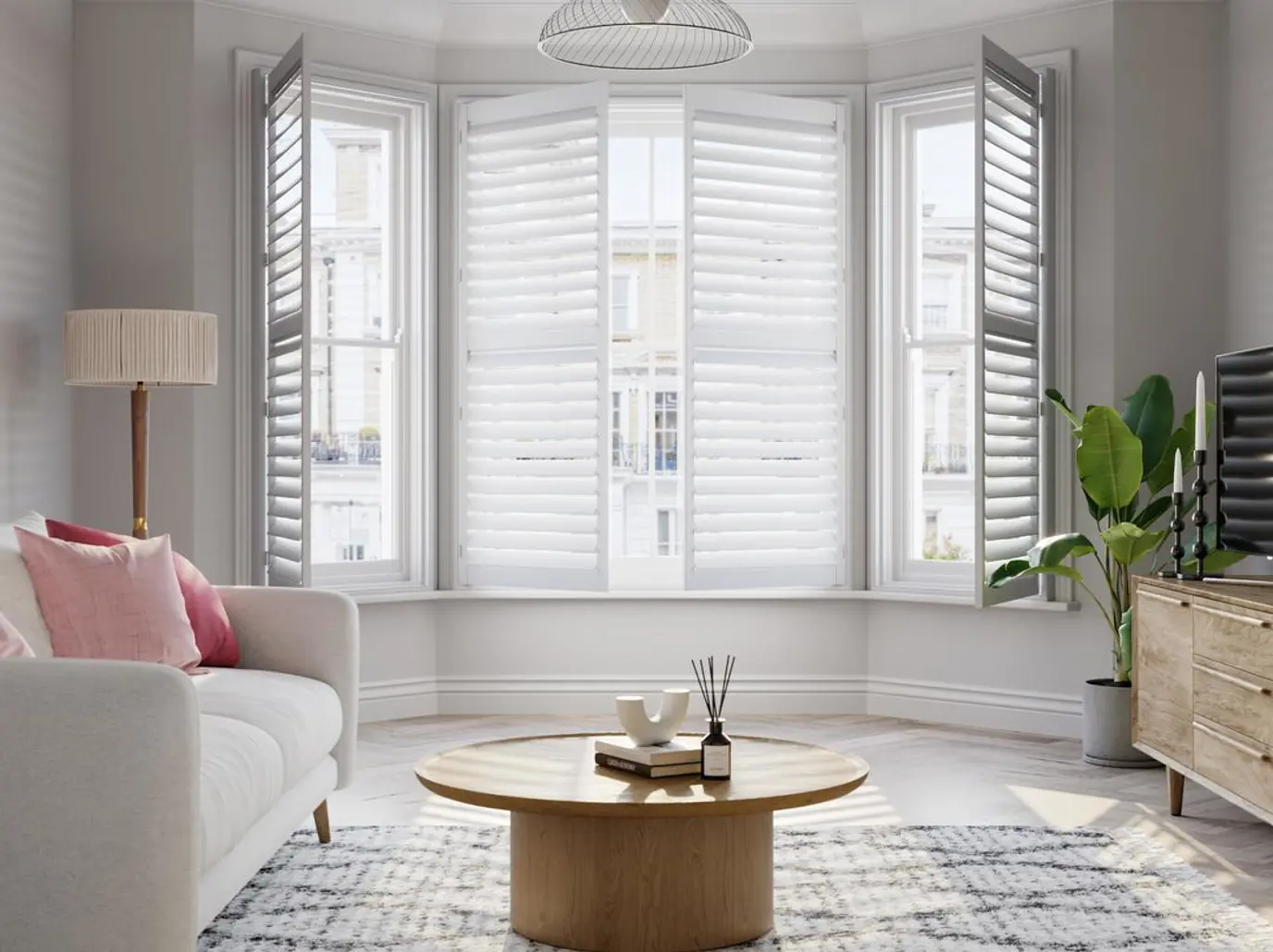 Vivid White wooden bay window shutters with cream sofa