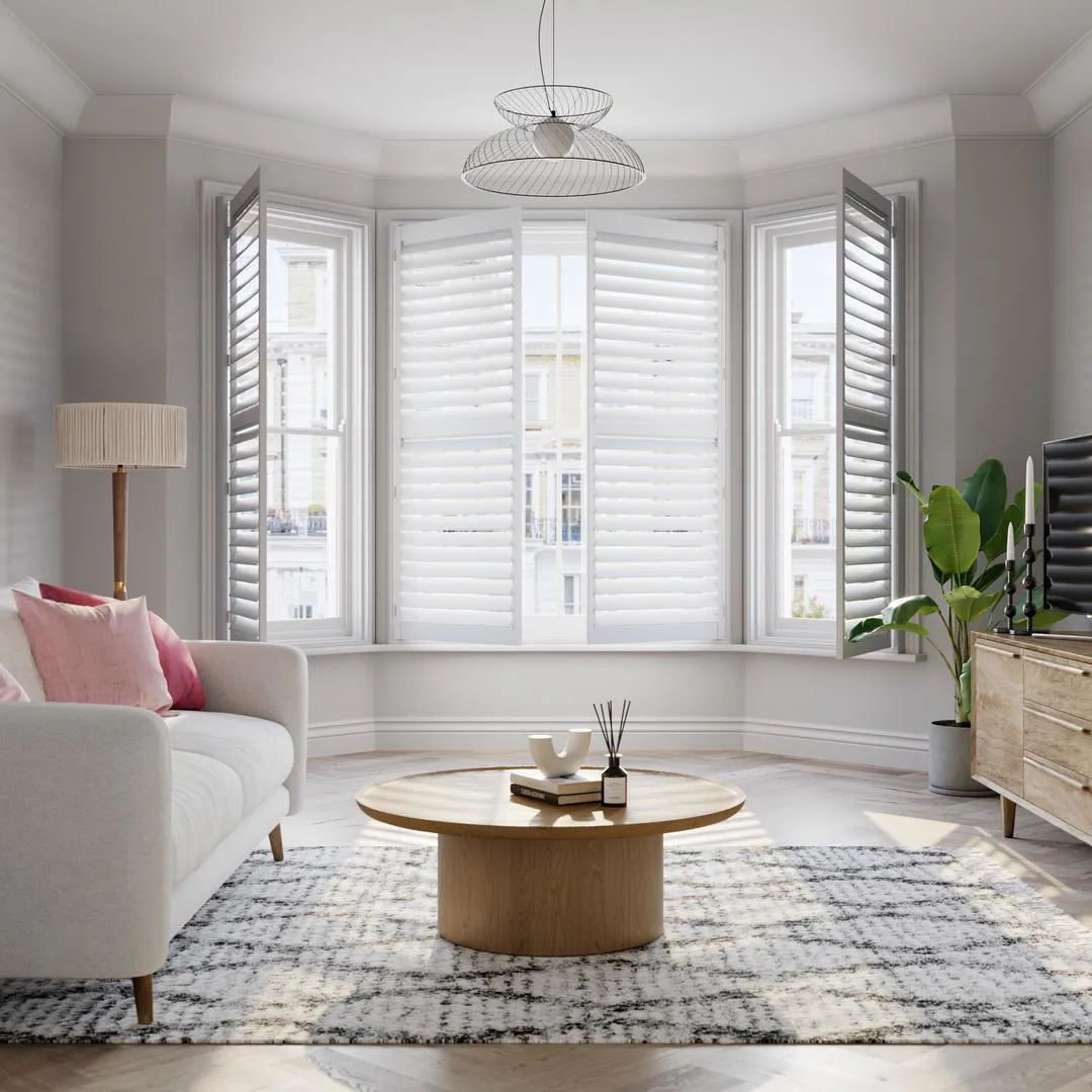 Vivid White wooden bay window shutters with cream sofa