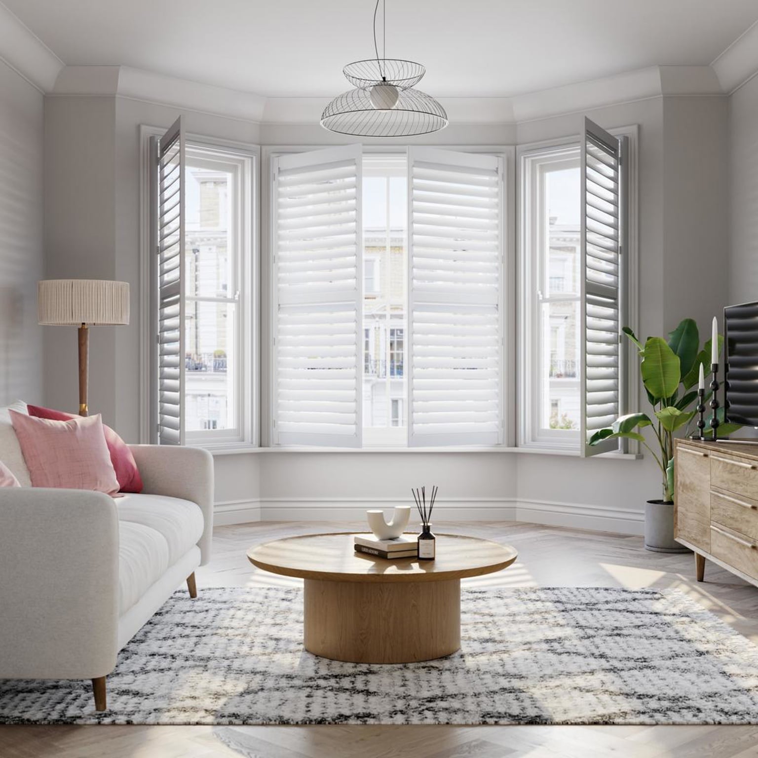 Vivid White wooden bay window shutters with cream sofa