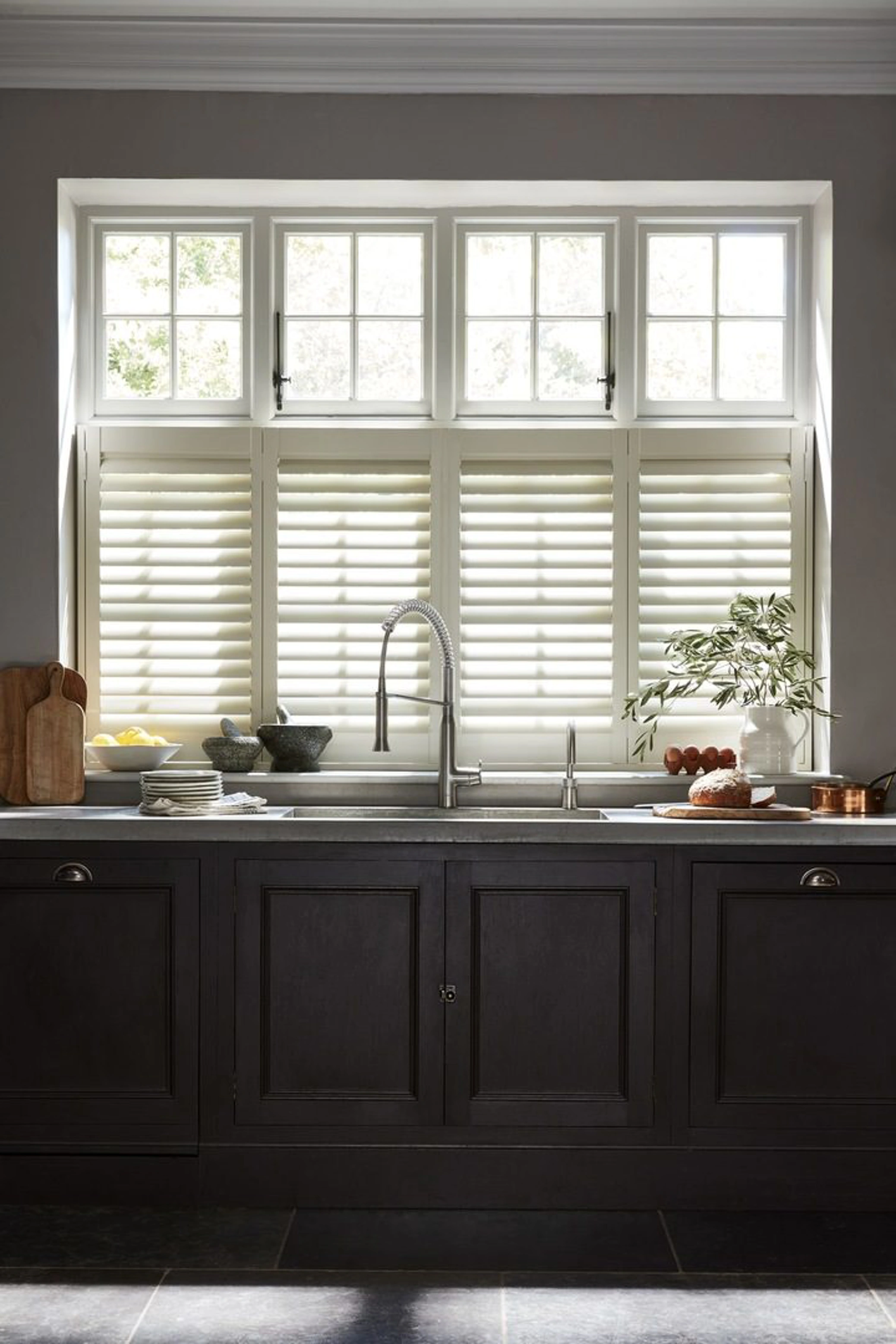Cafe Style cream shutters in black kitchen