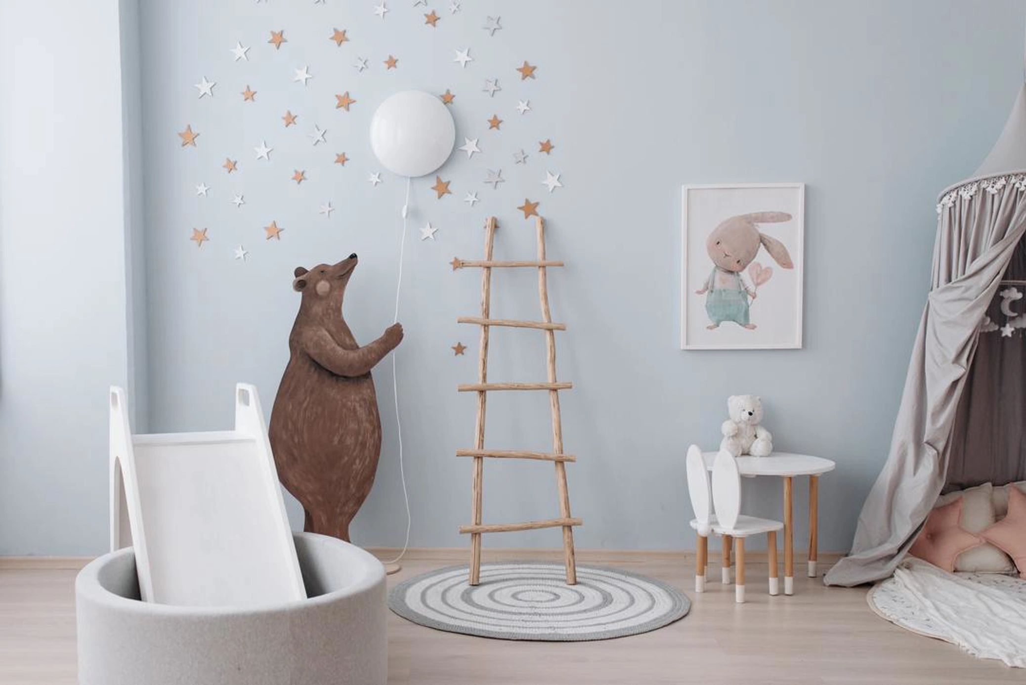Nursery with blue walls and neutral decor