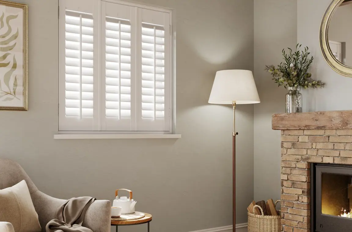 Cottage living room with White full height shutters 