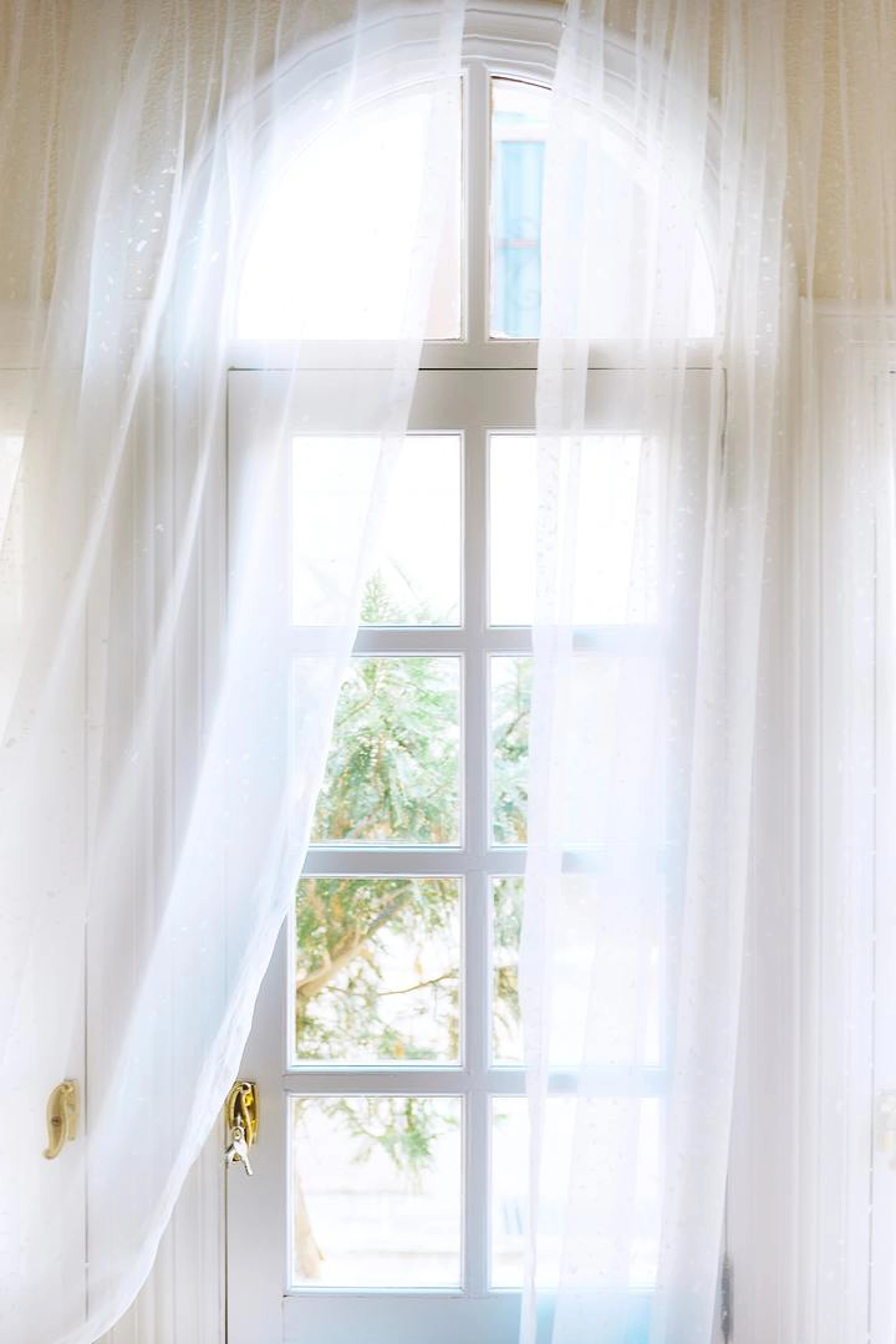 White net curtains on white door
