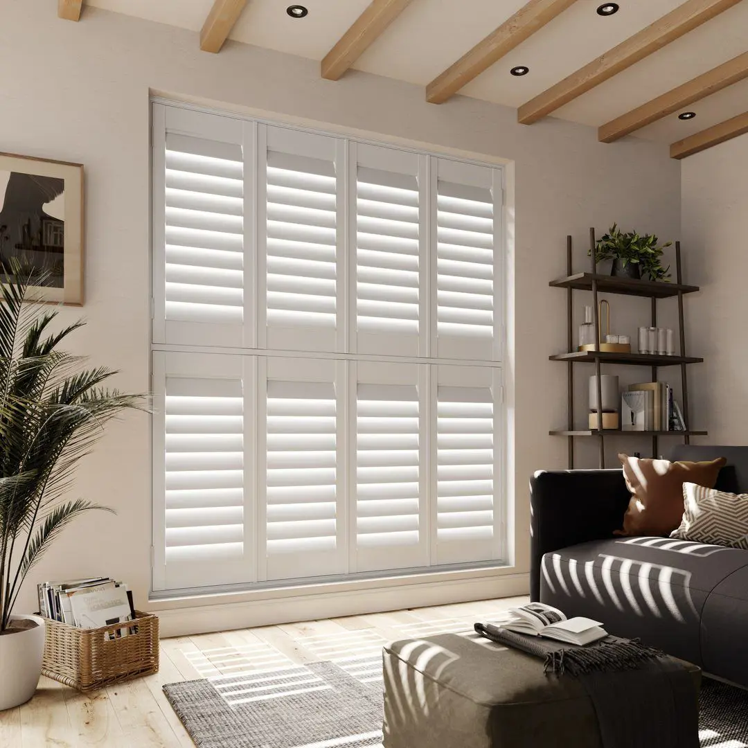 A neutral living room with Snow White tier on tier faux wood shutters 